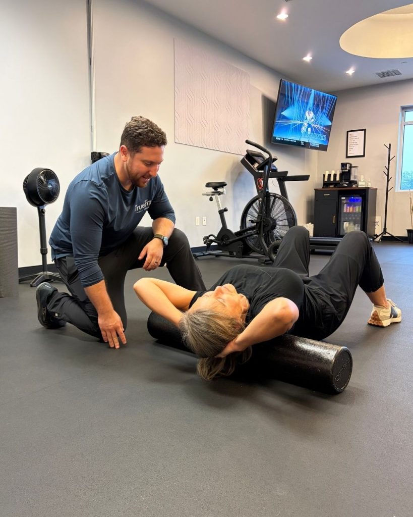 Physical therapist teaches a neck exercise at TrueFix Physical Therapy in Shawnee, KS