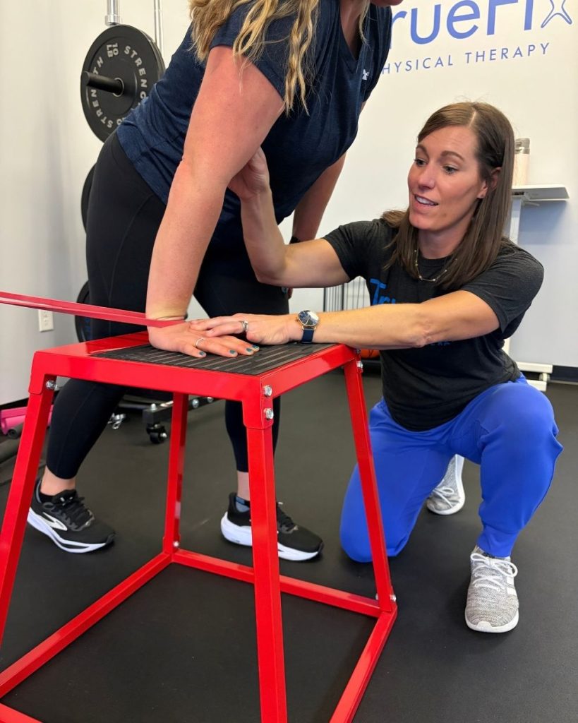 Physical therapist teaches wrist exercise at TrueFix Physical Therapy in Shawnee, KS