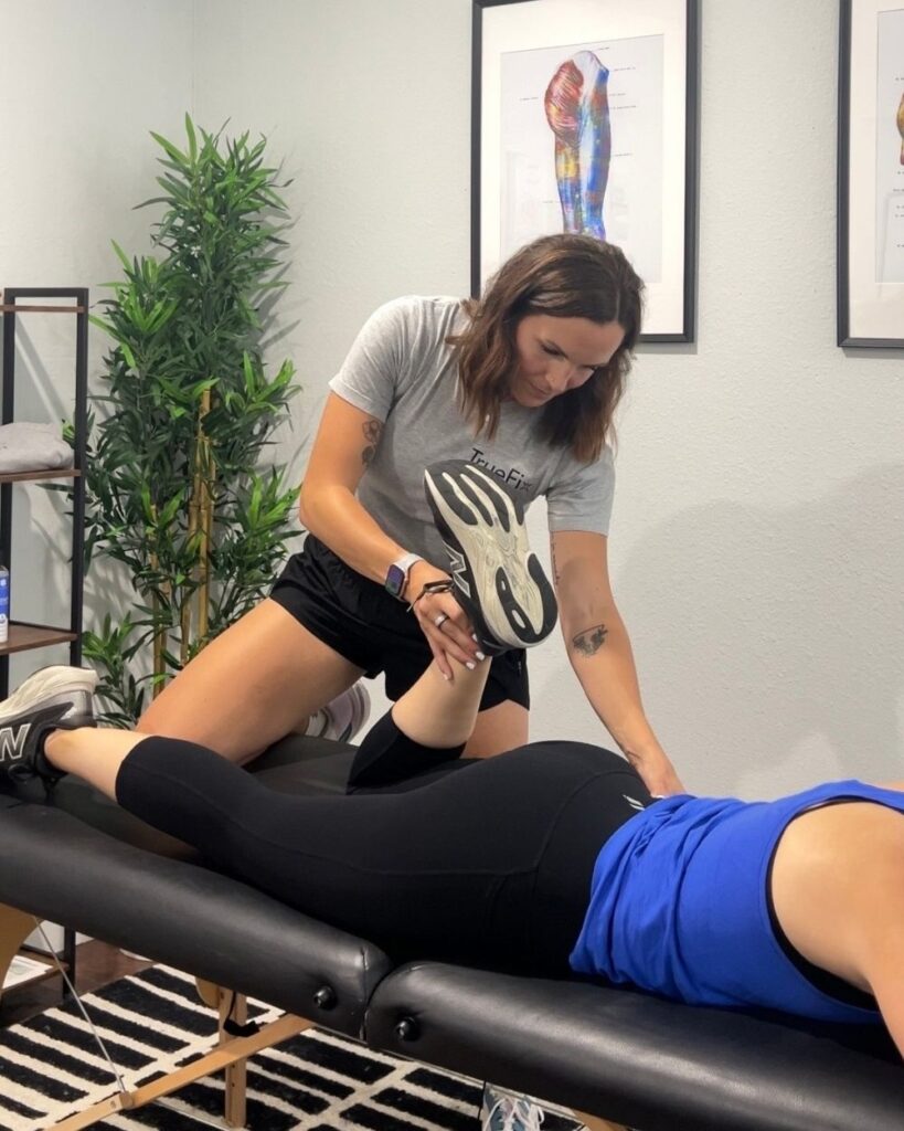 Physical therapist performs a foot assessment at TrueFix Physical Therapy in Mansfield, TX.